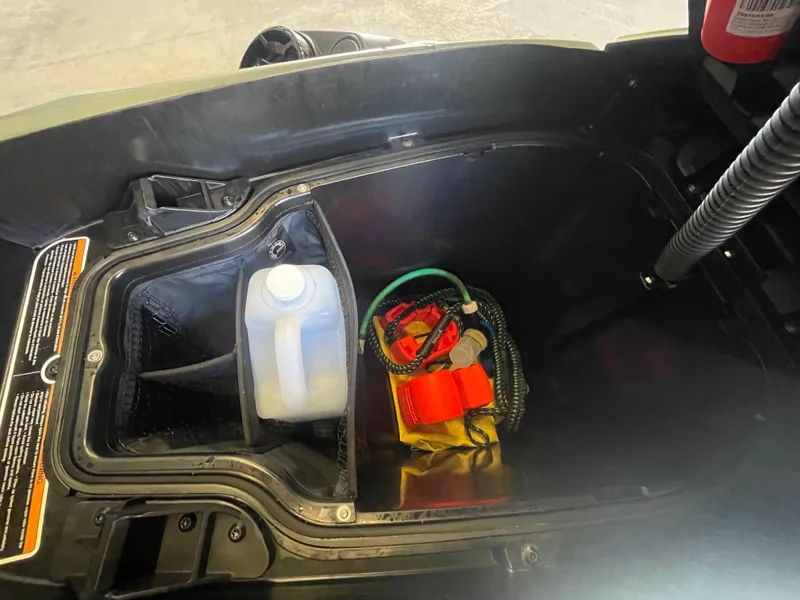 Slide: The Image of 2023 Sea-Doo GTX Limited 300 storage compartment with safety gear and water container. - 7