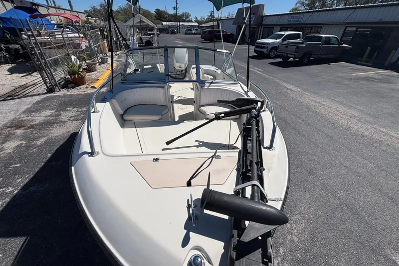 Slide: The Image of 2000 Sea Pro 180 Dual Console boat parked outdoors, showcasing seating and equipment. - 10