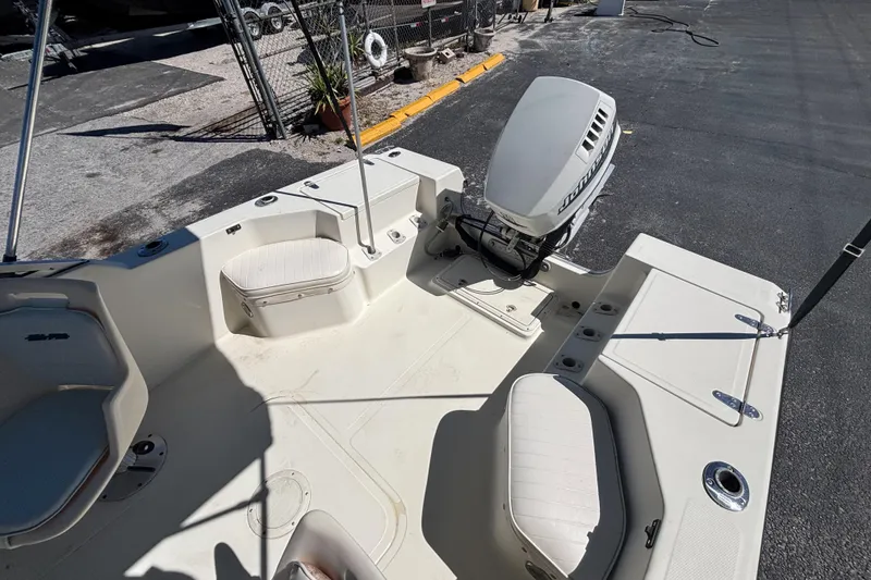 Slide: The Image of 2000 Sea Pro 180 Dual Console boat interior with seating and outboard motor. - 12