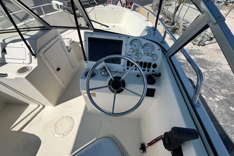 Slide: The Image of 2000 Sea Pro 180 Dual Console boat dashboard with steering wheel and gauges. - 18