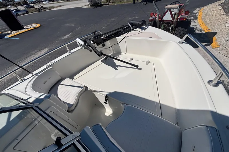 Slide: The Image of 2000 Sea Pro 180 Dual Console boat interior with seating and mounted equipment. - 19