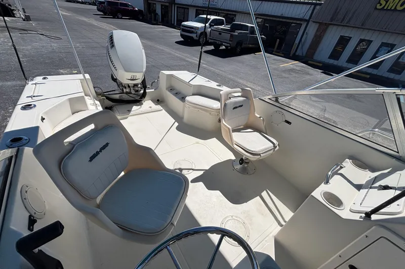 Slide: The Image of 2000 Sea Pro 180 Dual Console boat interior with seating and steering wheel. - 20