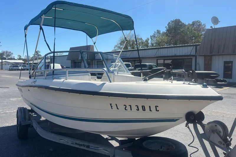 Slide: The Image of 2000 Sea Pro 180 Dual Console boat on trailer with canopy in parking lot. - 6