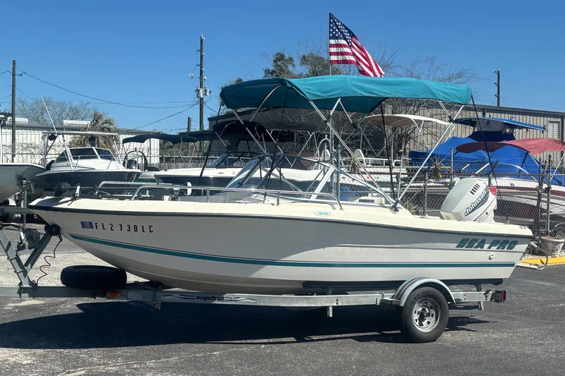Slide: The Image of 2000 Sea Pro 180 Dual Console boat on trailer, American flag in background. - 9