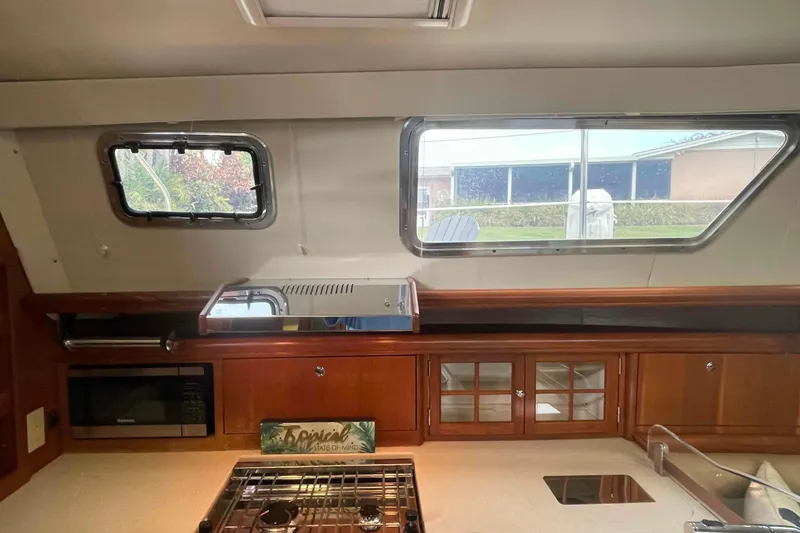 Slide: The Image of Interior of 2003 Hunter 426 Deck Salon yacht kitchen with stove and cabinets. - 104