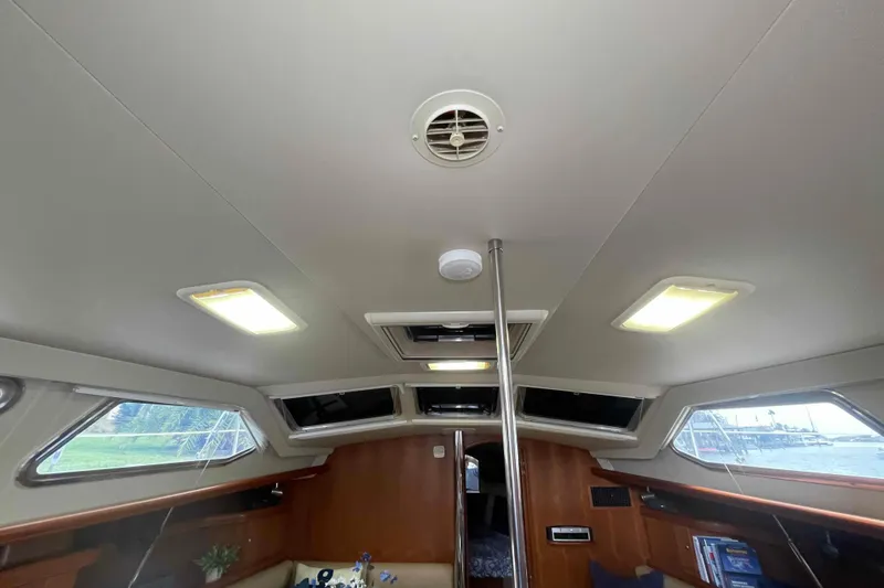 Slide: The Image of Interior view of 2003 Hunter 426 Deck Salon, featuring ceiling lights and windows and all new headliner in salon. - 105