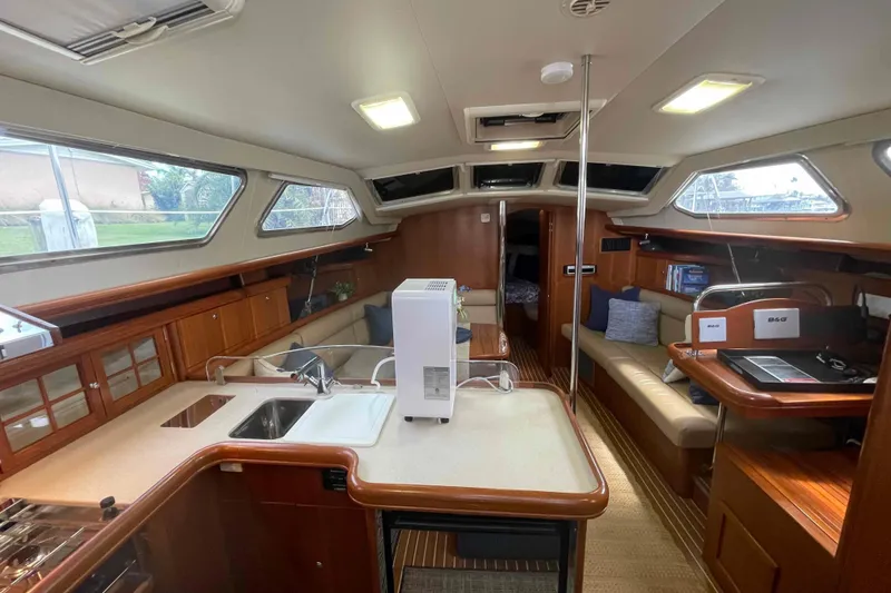 Slide: The Image of Interior of 2003 Hunter 426 Deck Salon yacht with modern amenities and seating area.  All new headliner in salon and v-berth. - 106