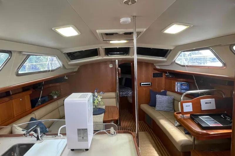 Slide: The Image of Interior of 2003 Hunter 426 Deck Salon yacht with modern amenities and comfortable seating. - 107