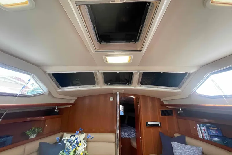 Slide: The Image of Interior of 2003 Hunter 426 Deck Salon with skylights and cozy seating area.  All new headliner. - 109