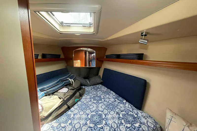 Slide: The Image of Cozy cabin interior of 2003 Hunter 426 Deck Salon sailboat with skylight and patterned bedding. - 112