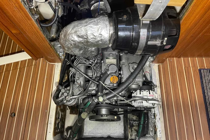 Slide: The Image of Engine compartment of 2003 Hunter 426 Deck Salon sailboat, showcasing detailed mechanical components. - 17