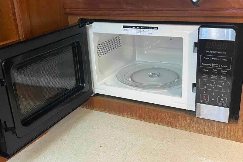 Slide: The Image of Open microwave oven in a 2003 Hunter 426 Deck Salon kitchen area. - 25
