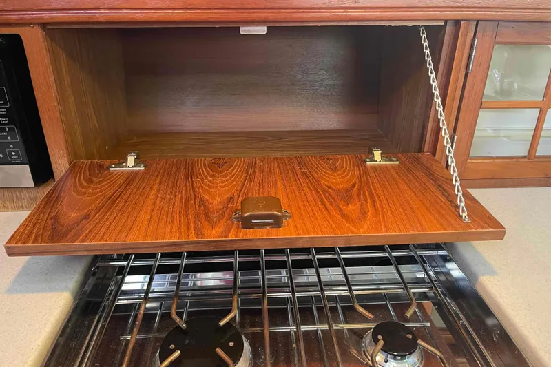 Slide: The Image of Wooden cabinet and stove in 2003 Hunter 426 Deck Salon yacht kitchen. - 26
