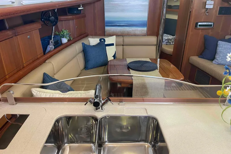 Slide: The Image of Interior of 2003 Hunter 426 Deck Salon with cozy seating and modern kitchen sink. - 29