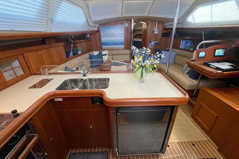 Slide: The Image of Luxurious interior of 2003 Hunter 426 Deck Salon with modern kitchen and cozy seating area. - 3