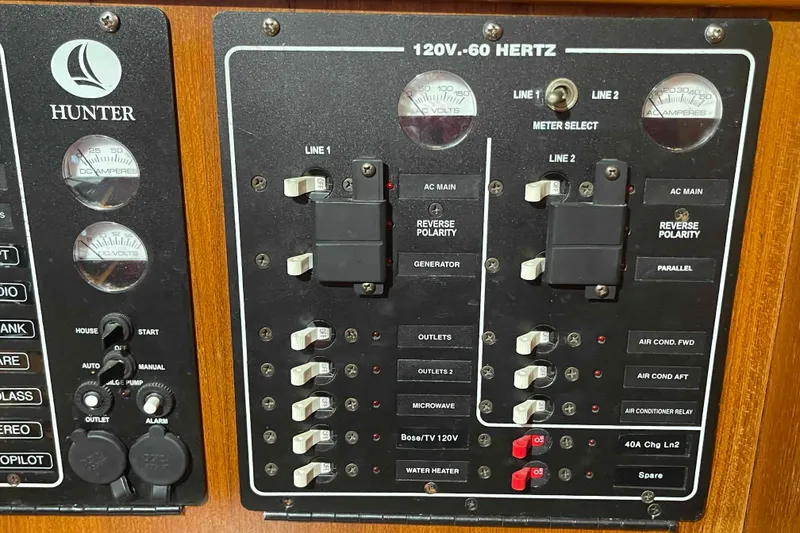 Slide: The Image of Electrical panel of 2003 Hunter 426 Deck Salon sailboat, showing switches and meters. - 35