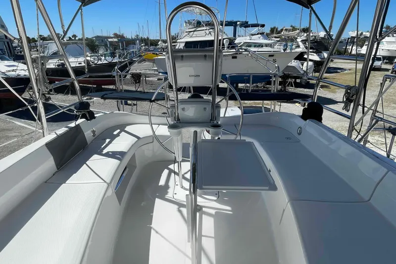 Slide: The Image of Hunter 426 Deck Salon 2003 yacht cockpit with steering wheel and seating area. - 43