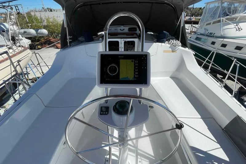 Slide: The Image of 2003 Hunter 426 Deck Salon cockpit with navigation system and steering wheel. - 47