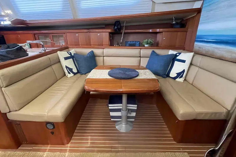 Slide: The Image of Interior of 2003 Hunter 426 Deck Salon with cozy seating and nautical decor. - 5