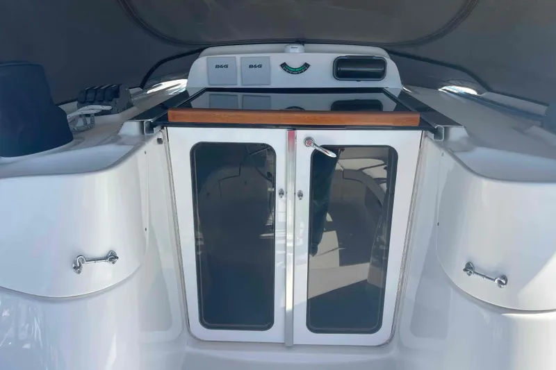 Slide: The Image of Hunter 426 Deck Salon 2003 yacht cockpit with glass doors and navigation equipment. - 53