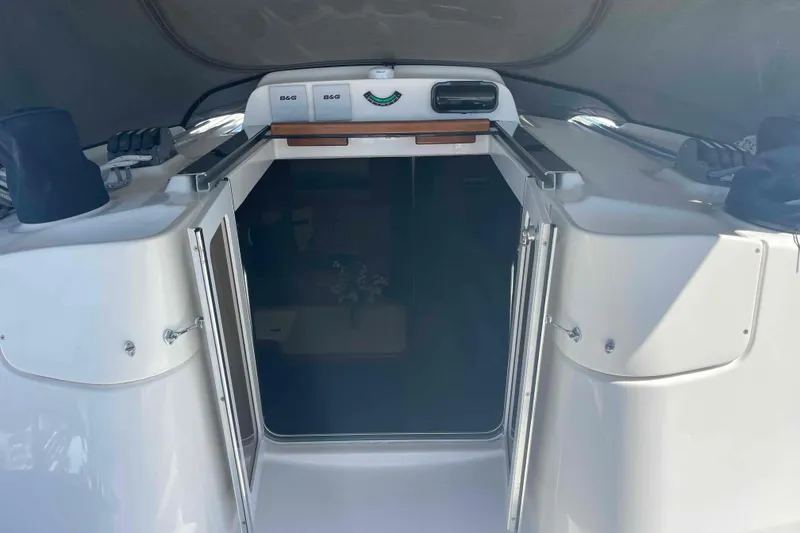 Slide: The Image of Entrance to 2003 Hunter 426 Deck Salon yacht, featuring open doors and navigation equipment. - 54