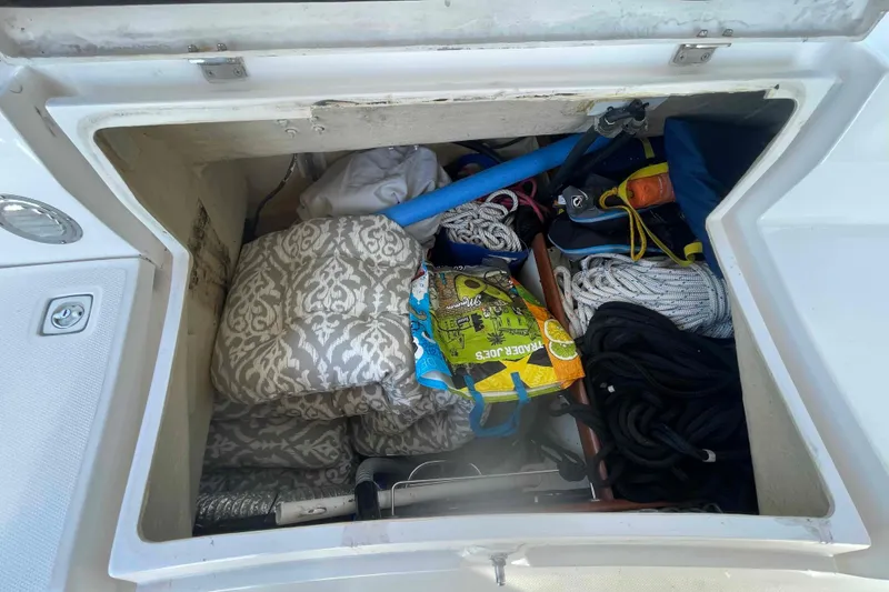 Slide: The Image of Storage compartment of 2003 Hunter 426 Deck Salon with ropes, cushions, and gear. - 61