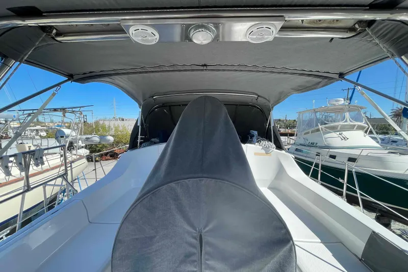 Slide: The Image of 2003 Hunter 426 Deck Salon sailboat with covered cockpit and marina view. - 64