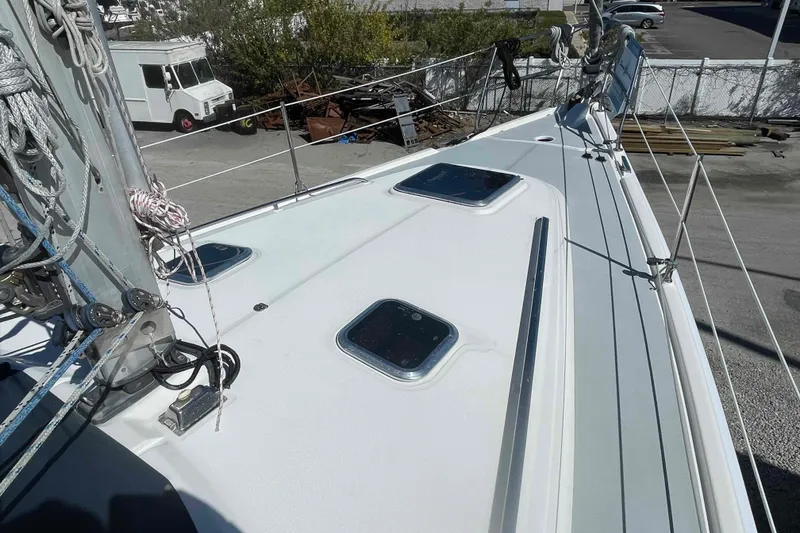 Slide: The Image of 2003 Hunter 426 Deck Salon sailboat deck with hatches and rigging. - 67