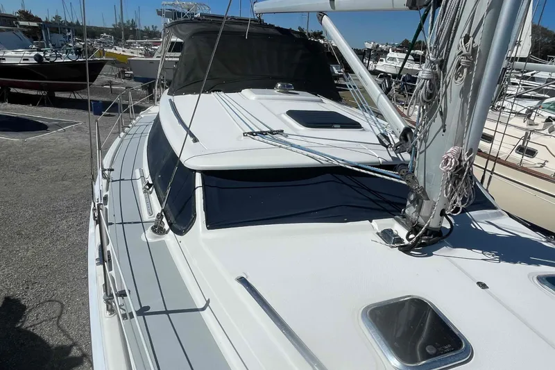Slide: The Image of Hunter 426 Deck Salon 2003 sailboat docked, showcasing sleek design and rigging details. - 71