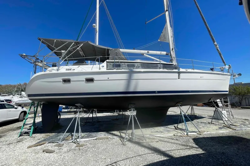 Slide: The Image of 2003 Hunter 426 Deck Salon sailboat on stands, clear blue sky background. - 73