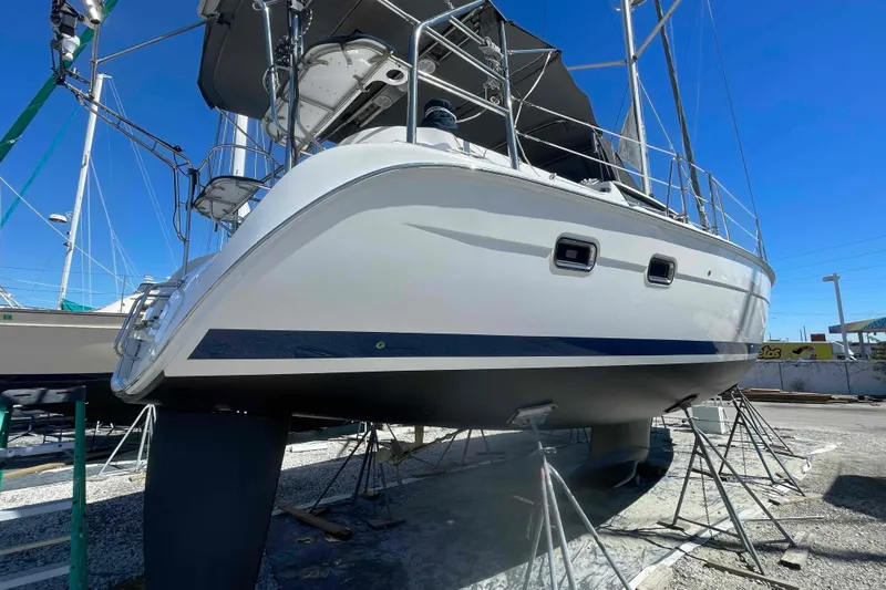 Slide: The Image of 2003 Hunter 426 Deck Salon sailboat on stands, viewed from the stern in a boatyard. - 74