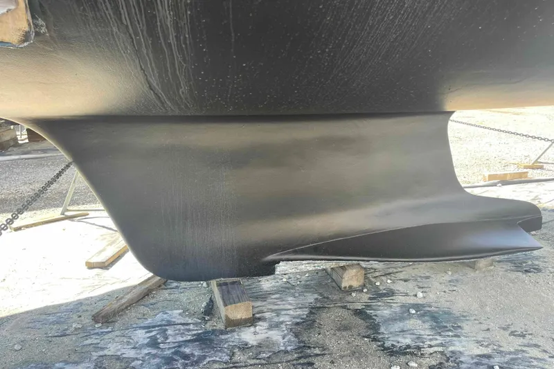 Slide: The Image of 2003 Hunter 426 Deck Salon keel, black finish, on dry dock. - 82