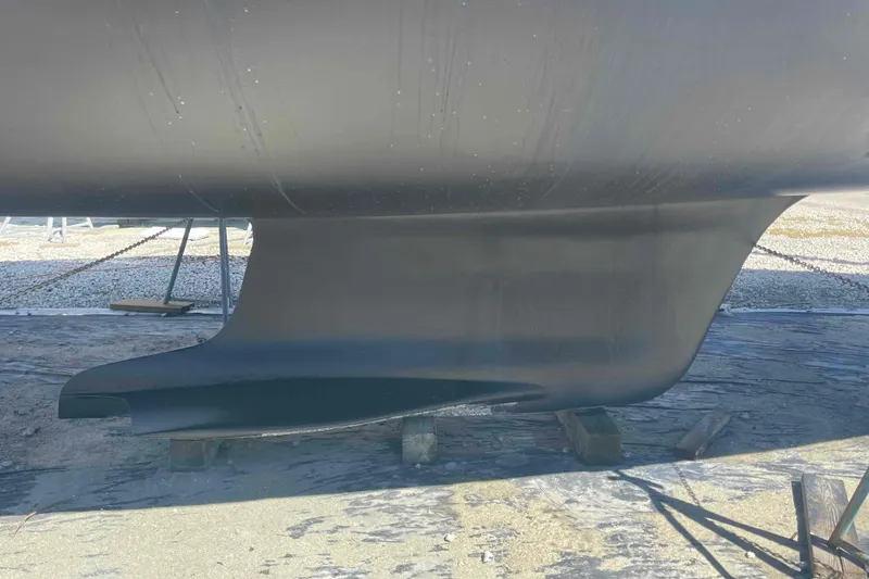 Slide: The Image of 2003 Hunter 426 Deck Salon keel on dry dock, showcasing sleek design. - 85