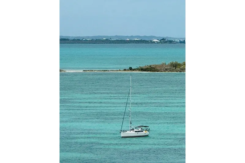 Slide: The Image of Sailboat "Hunter 426 Deck Salon" 2003 on turquoise waters with distant shoreline. - 90