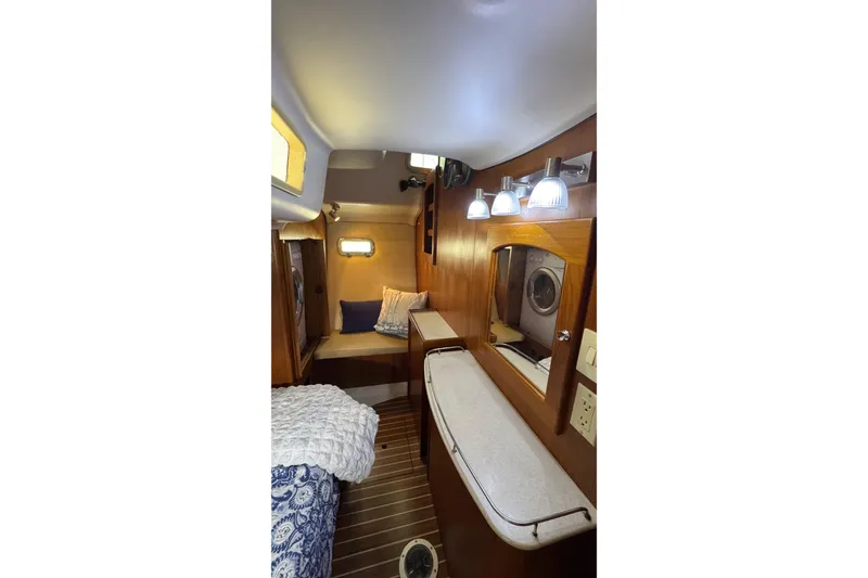Slide: The Image of Interior of 2003 Hunter 426 Deck Salon, featuring cozy cabin with wood accents and lighting. - 99