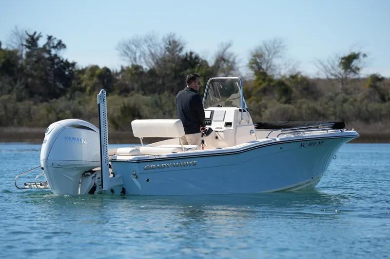 Slide: The Image of 2025 Grady-White Fisherman 180 boat on calm water, featuring Yamaha outboard motor. - 11