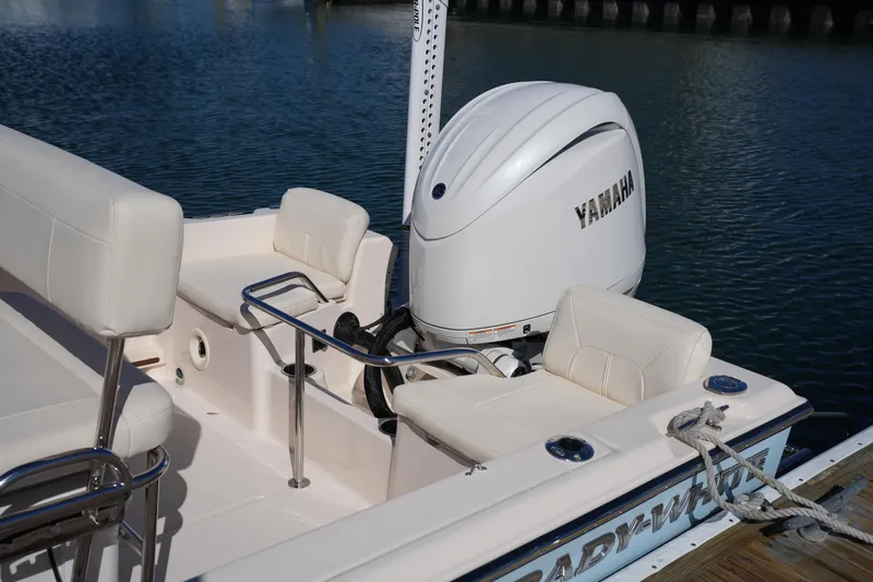 Slide: The Image of 2025 Grady-White Fisherman 180 boat with Yamaha engine, docked on calm water. - 14