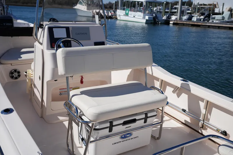 Slide: The Image of 2025 Grady-White Fisherman 180 boat interior with seating and console, docked at marina. - 16