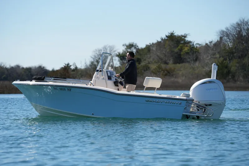 Slide: The Image of 2025 Grady-White Fisherman 180 boat cruising on calm water. - 2