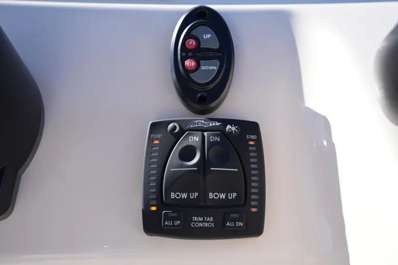 Slide: The Image of Control panel of 2025 Grady-White Fisherman 180 boat with trim tab controls. - 25