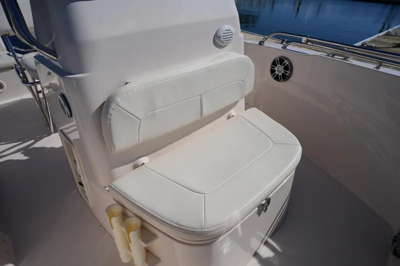 Slide: The Image of 2025 Grady-White Fisherman 180 boat seat with white upholstery and storage compartment. - 26