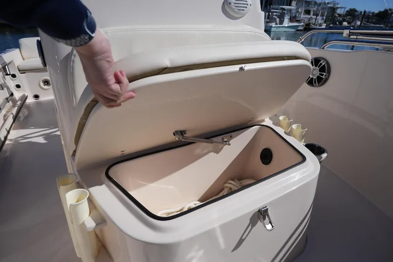 Slide: The Image of 2025 Grady-White Fisherman 180 boat storage compartment with open lid and rope inside. - 27
