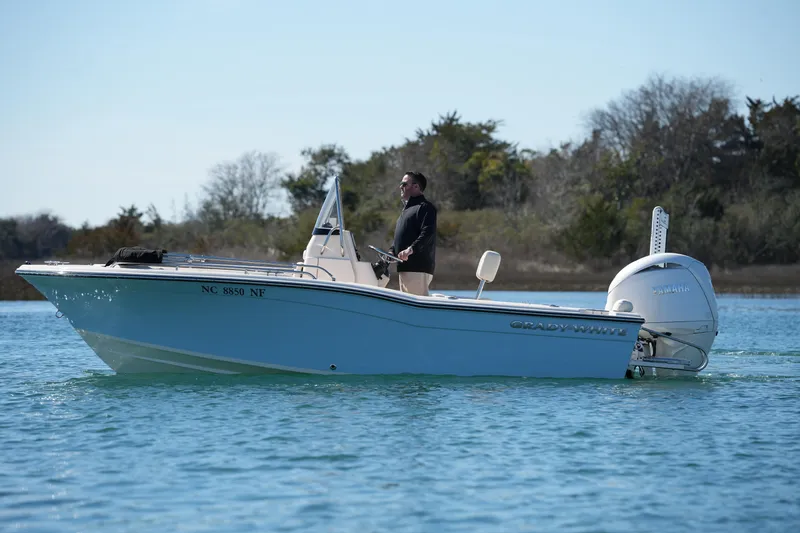 Slide: The Image of 2025 Grady-White Fisherman 180 boat on calm water, with a person steering. - 3