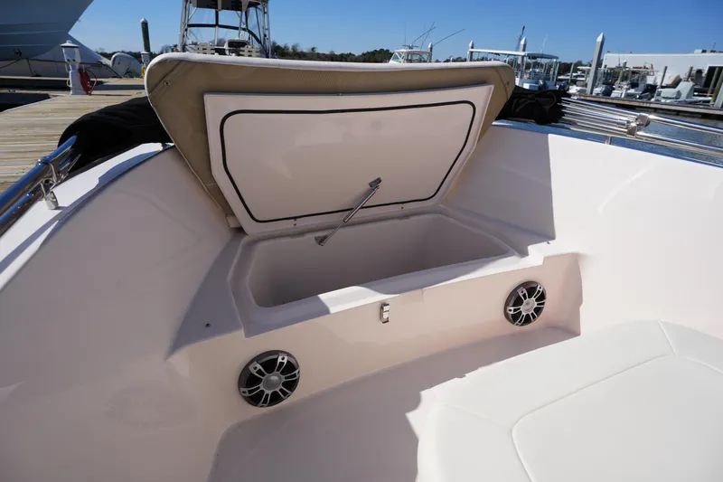 Slide: The Image of 2025 Grady-White Fisherman 180 boat storage compartment with open lid and speakers. - 30