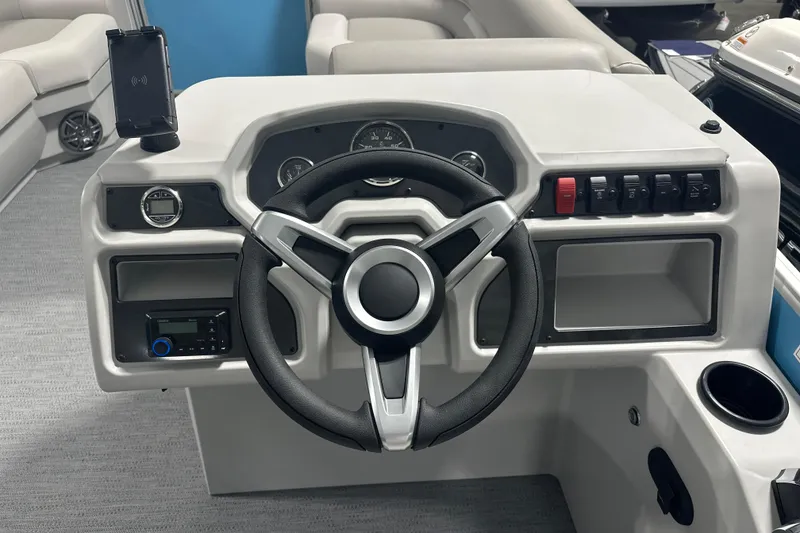 Slide: The Image of 2026 Godfrey EX 2286 SFLX boat dashboard with steering wheel and control panel. - 6