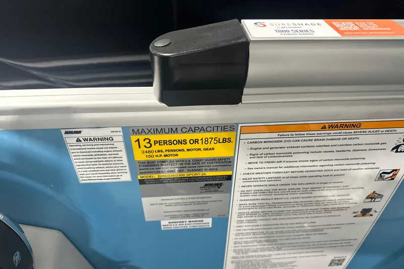 Slide: The Image of Warning labels and capacity information on a 2026 Godfrey EX 2286 SFLX boat. - 7