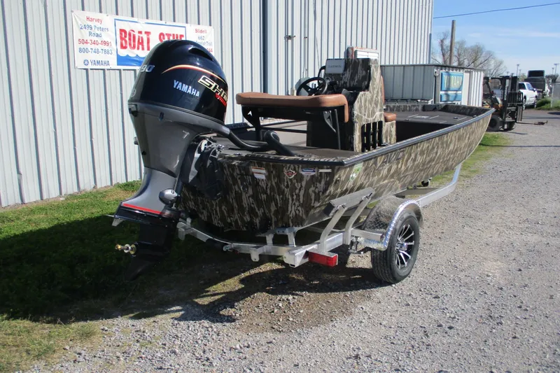 Slide: The Image of 2026 Avid 18 Rogue CC boat with Yamaha motor on trailer, camo design. - 5
