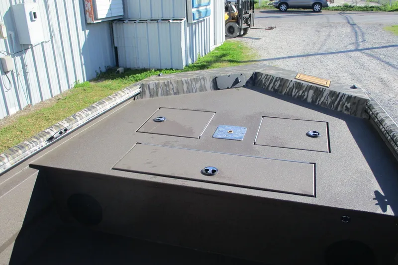 Slide: The Image of Avid 18 Rogue CC 2026 boat interior with storage compartments and camouflage design. - 7