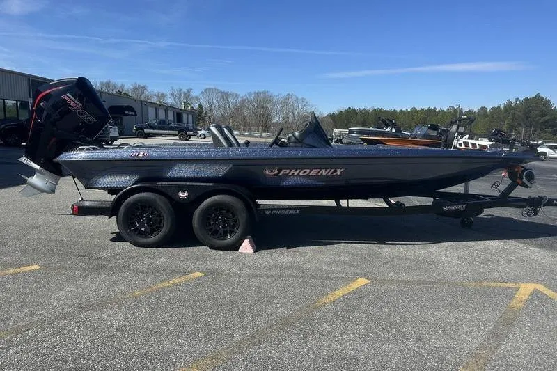 The Image of 2026 Phoenix 721 ZXL boat on trailer in parking lot, clear sky background. - 0