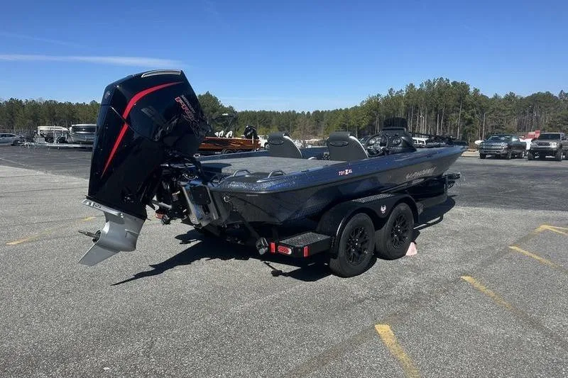 Slide: The Image of 2026 Phoenix 721 ZXL boat on trailer in parking lot, forest background. - 5